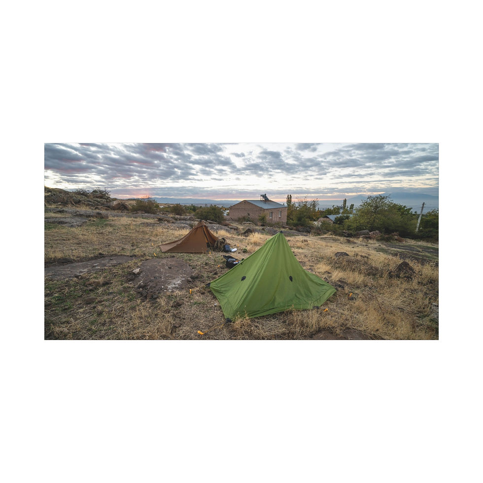Thumbnail: Green tent and brown tent camping on rocky terrain, cloudy sky.