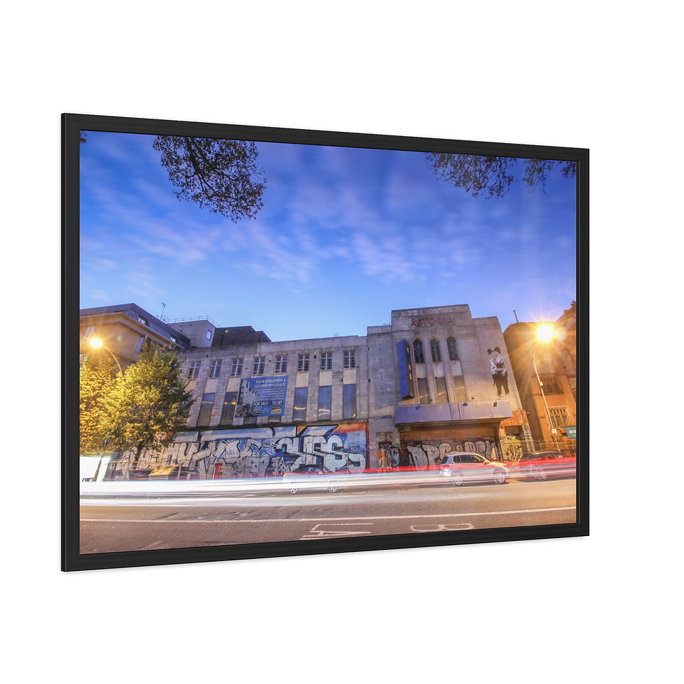 Thumbnail: Framed photo of city building at dusk with light trails on street.
