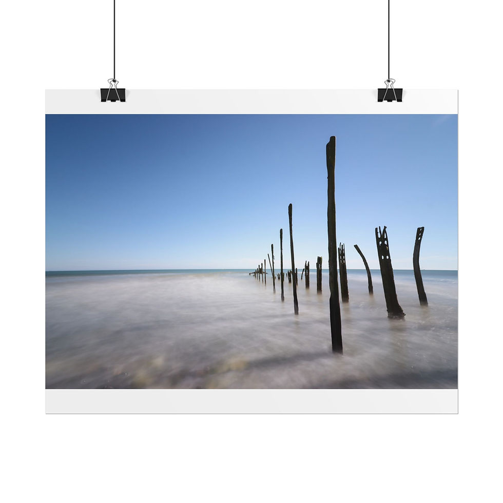 Thumbnail: Derelict wooden posts stand in calm ocean under a clear blue sky.