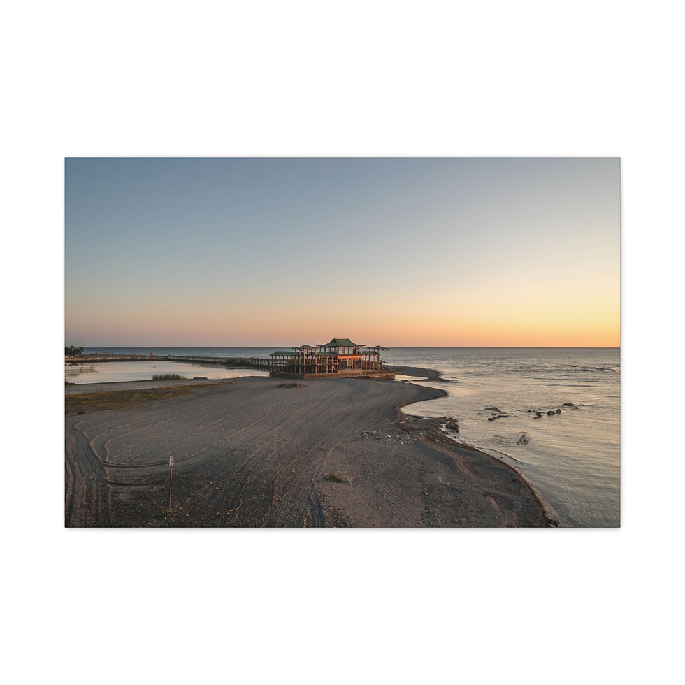 Thumbnail: Serene sunset over sandy beach, calm ocean, and distant building.