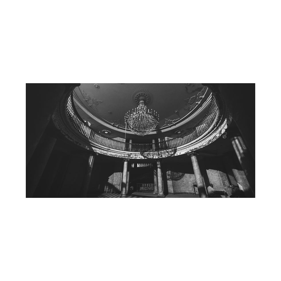 Thumbnail: Ornate chandelier in grand, abandoned domed building interior, black and white.