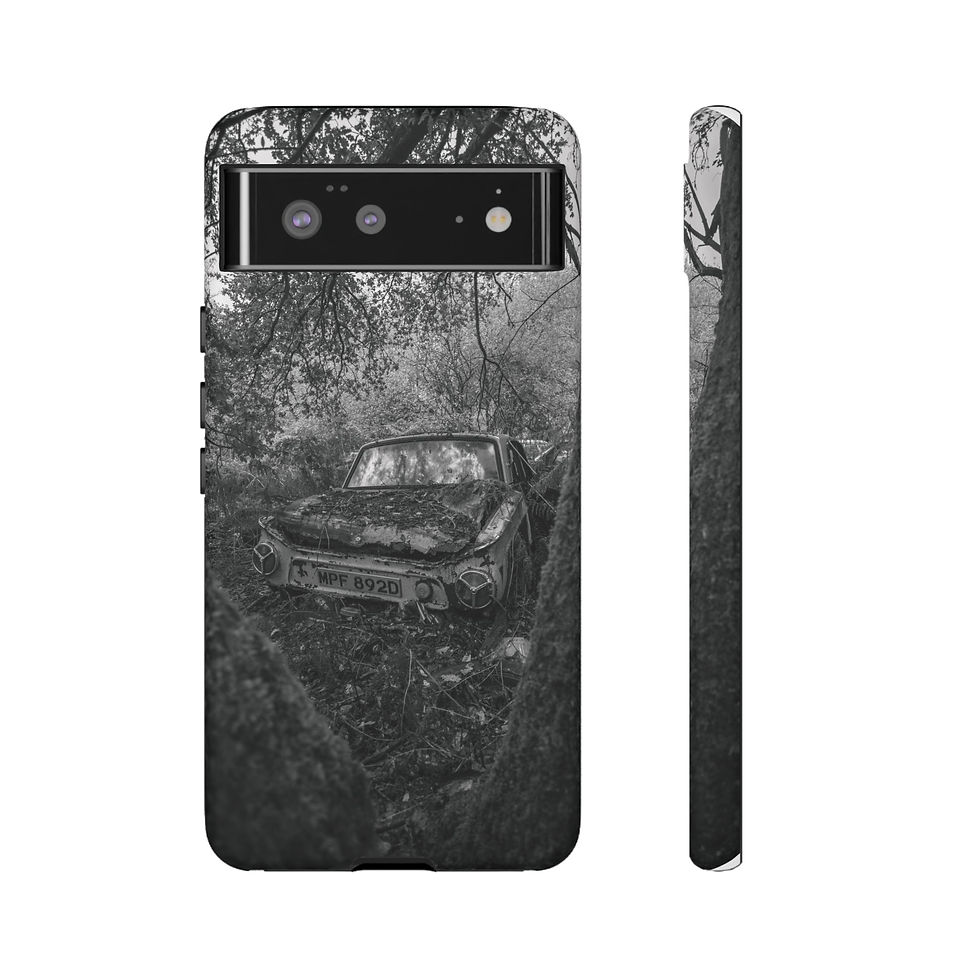 Thumbnail: Black and white Pixel phone case with abandoned car in overgrown forest.