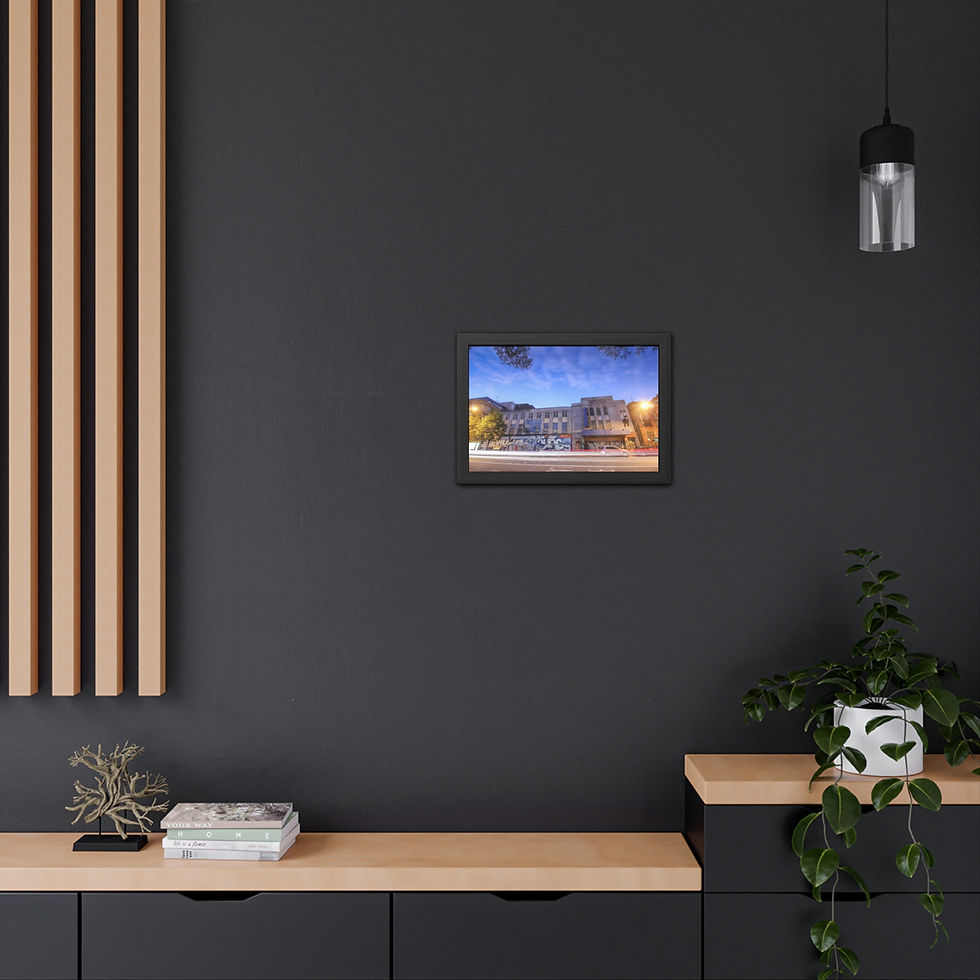 Thumbnail: Framed print of a large, illuminated building at night on dark wall.