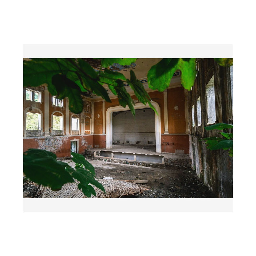 Thumbnail: Decaying abandoned hall, stage, overgrown with plants and broken windows.