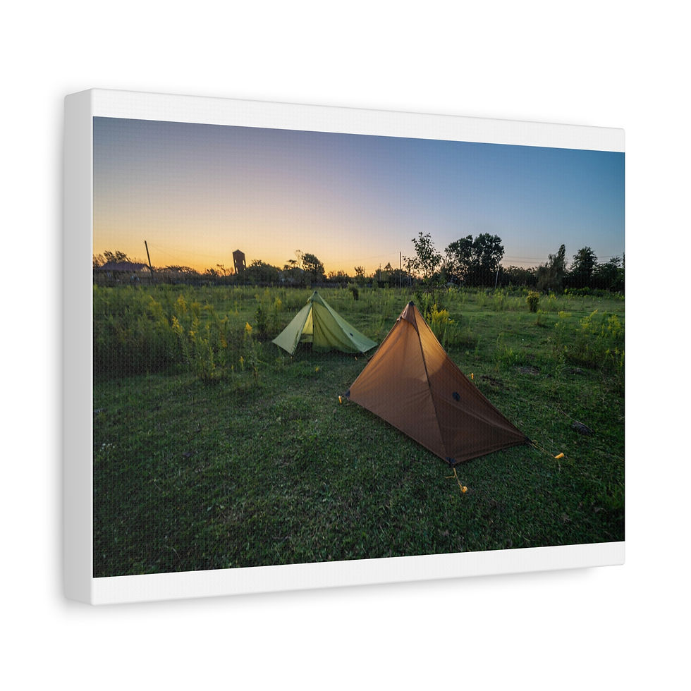 Thumbnail: Two colorful camping tents pitched in a lush green field at sunset.