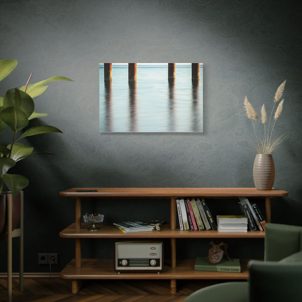 Thumbnail: Framed print of pier pilings reflecting in calm water above a console table.