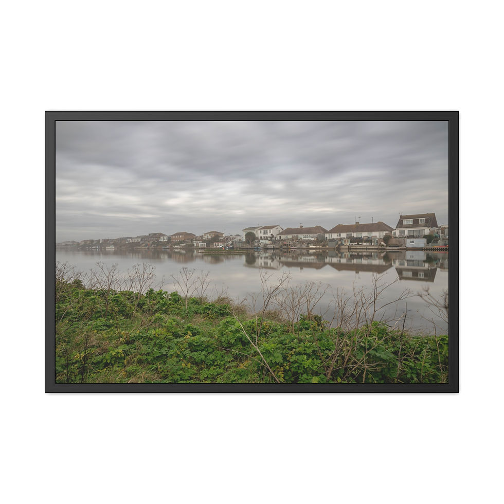 Thumbnail: Framed landscape photograph showing houses reflecting on water, overcast sky.