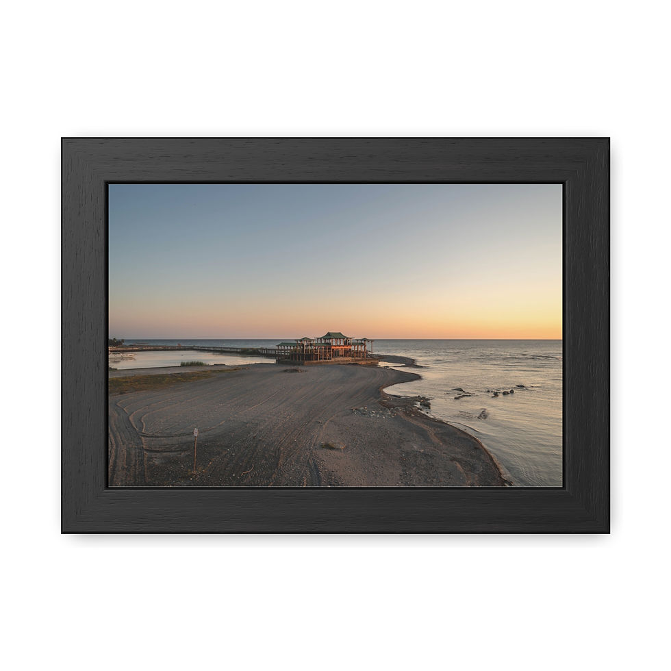 Thumbnail: Framed print of a sunset over sandy beach with building on jetty.