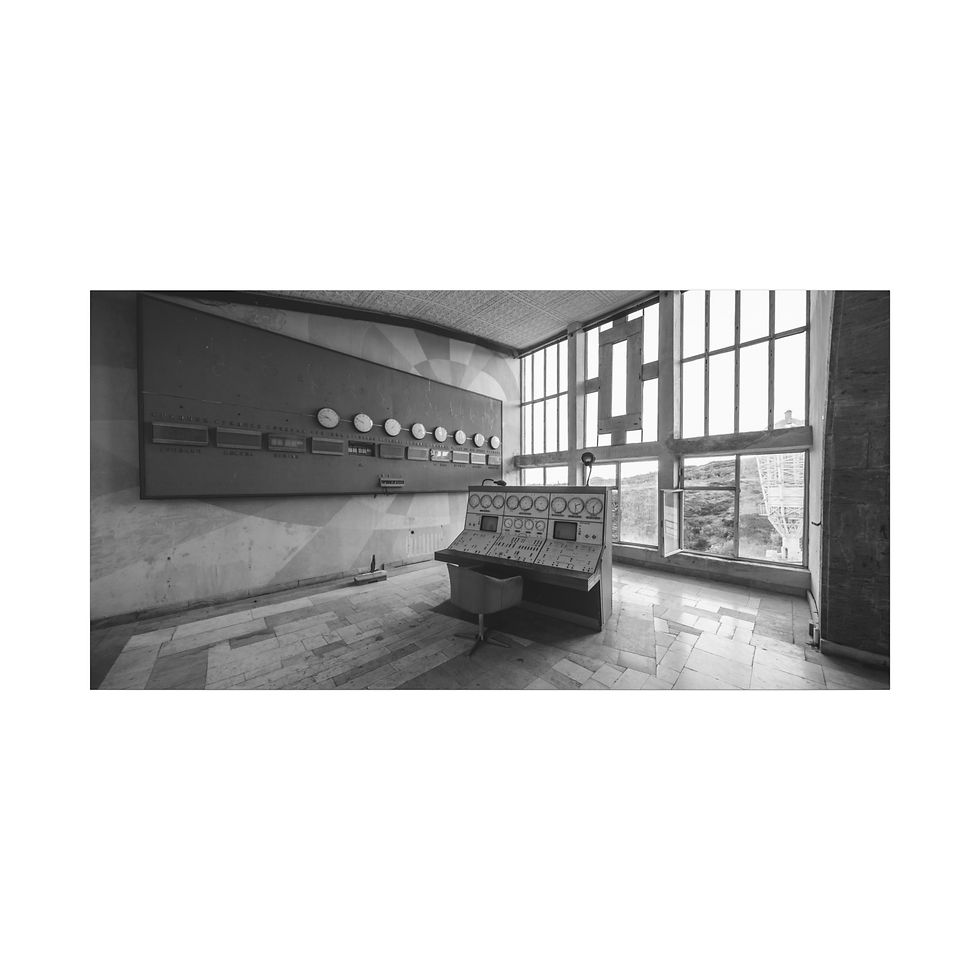 Thumbnail: Grayscale abandoned industrial control room with console, panel, large windows.