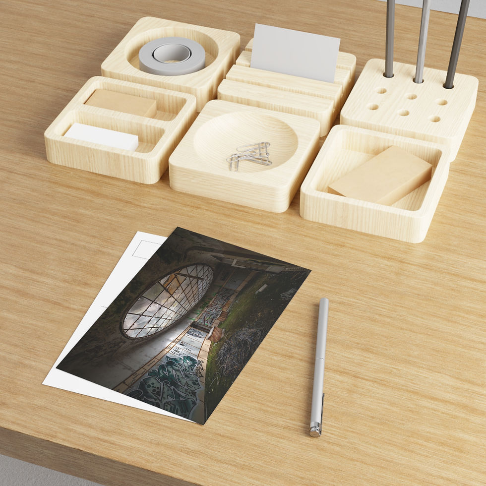 Thumbnail: Postcard with a large, ornate circular window on a wooden desk.