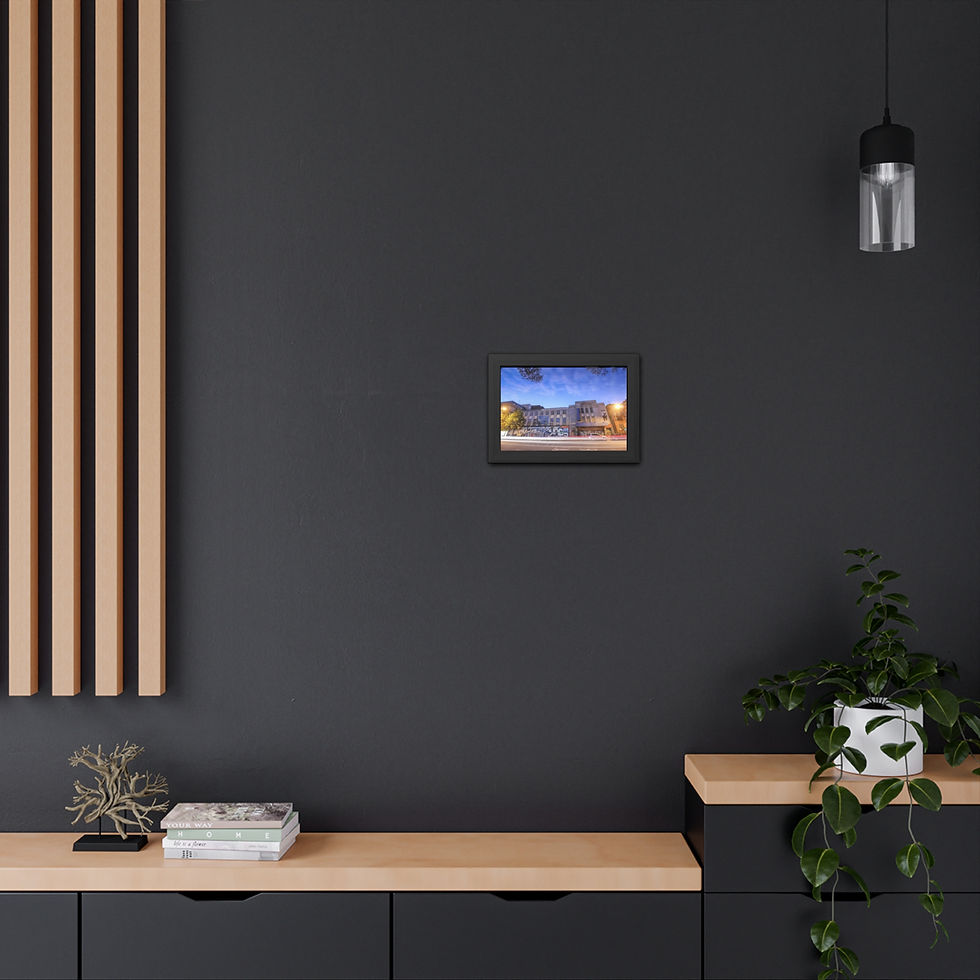 Thumbnail: Small framed art piece hangs on dark gray wall above wooden shelf.