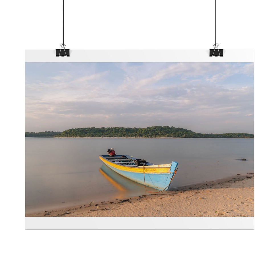 Thumbnail: Small blue and yellow wooden boat resting on sandy shore by calm lake.