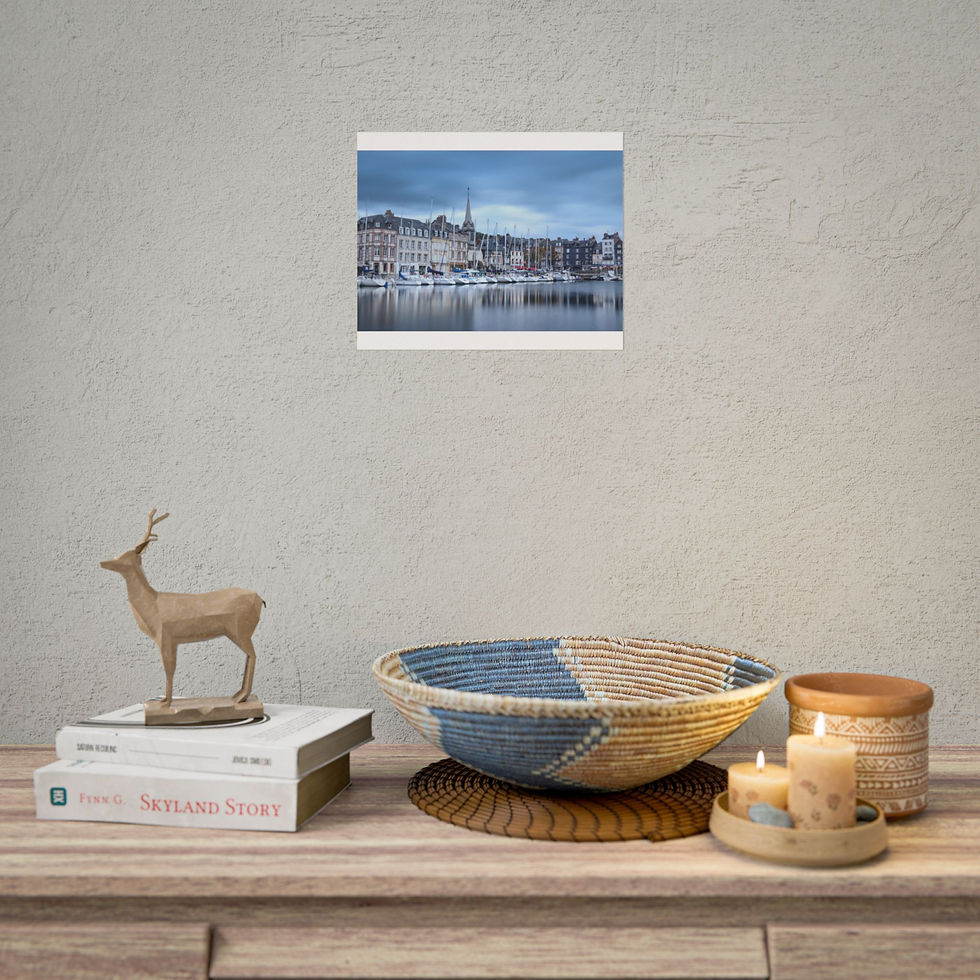 Thumbnail: Framed print of a European city harbor above a decorative table.