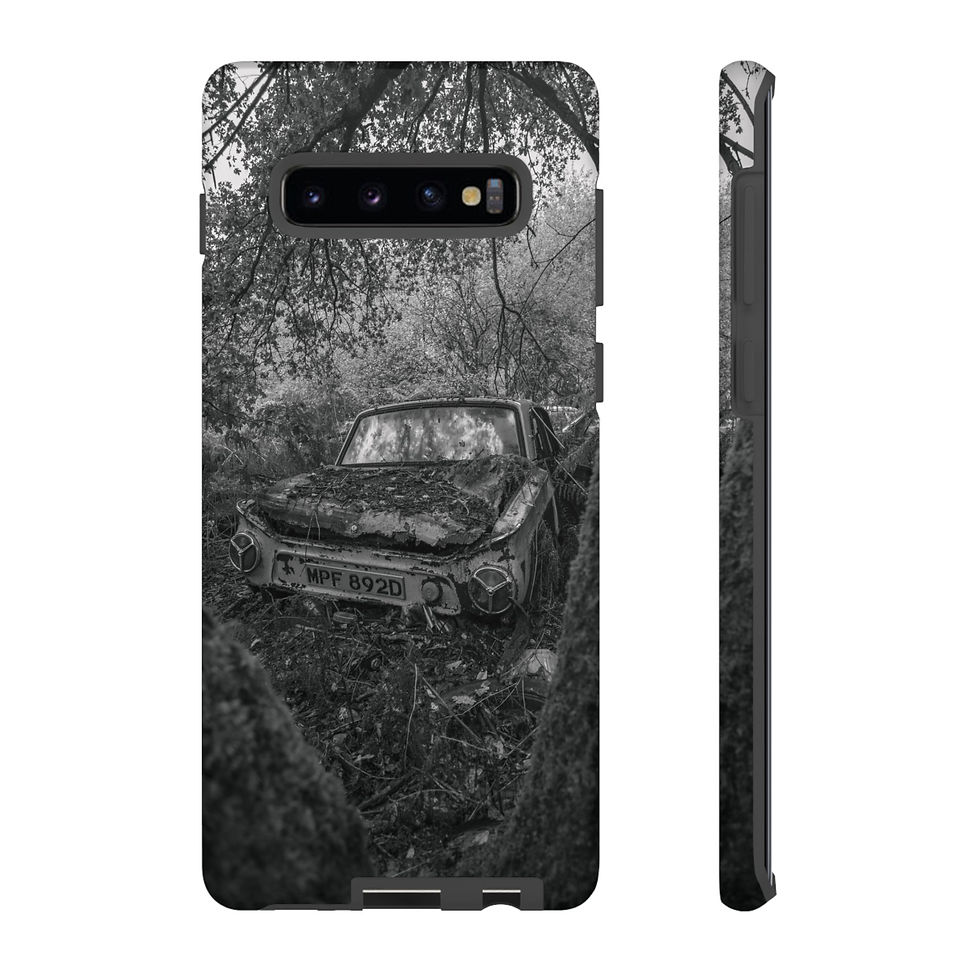 Thumbnail: Black and white phone case featuring abandoned, wrecked car overgrown in nature.