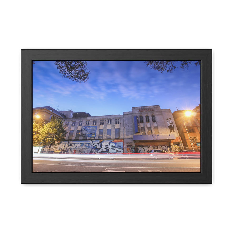 Thumbnail: Framed long exposure city building with graffiti, car light trails, twilight sky.