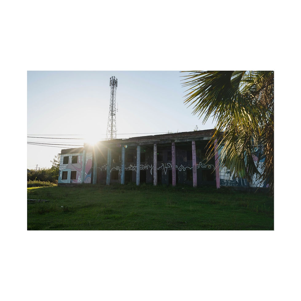 Thumbnail: Dilapidated abandoned building, sun's rays, communication tower, and palm.