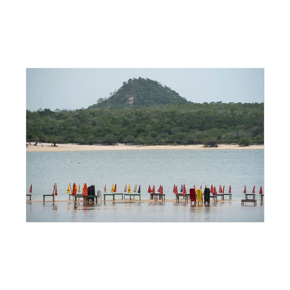 Thumbnail: Colorful wooden stands in shallow bay with green hill backdrop.