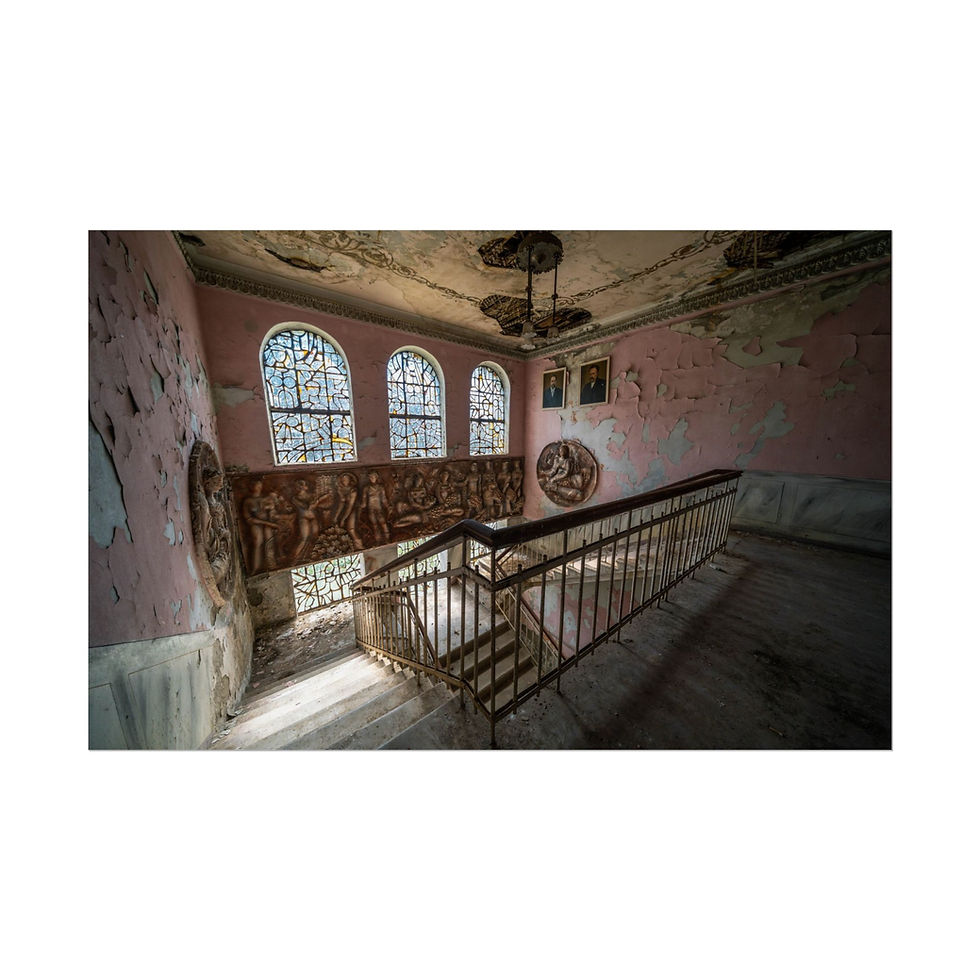 Thumbnail: Abandoned, decaying staircase with ornate railing, arched windows, and peeling pink walls.