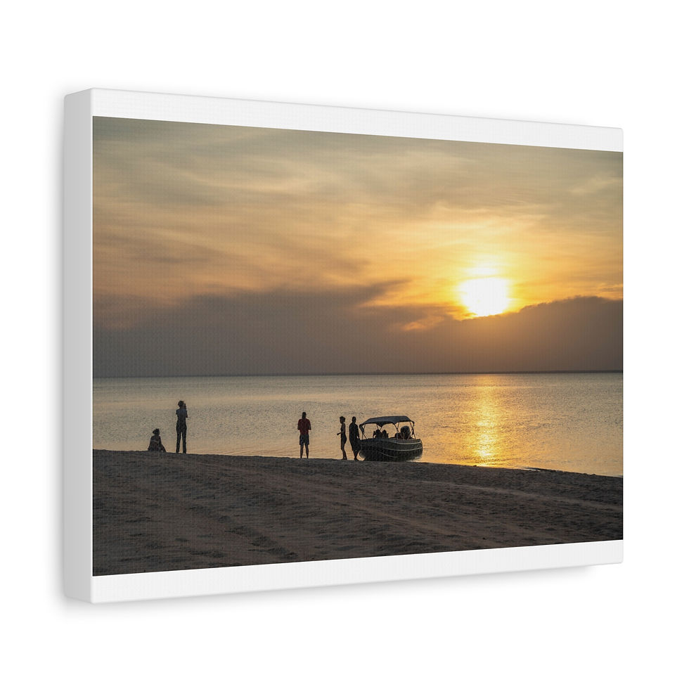 Thumbnail: People and boat silhouettes on sandy beach at golden sunset.