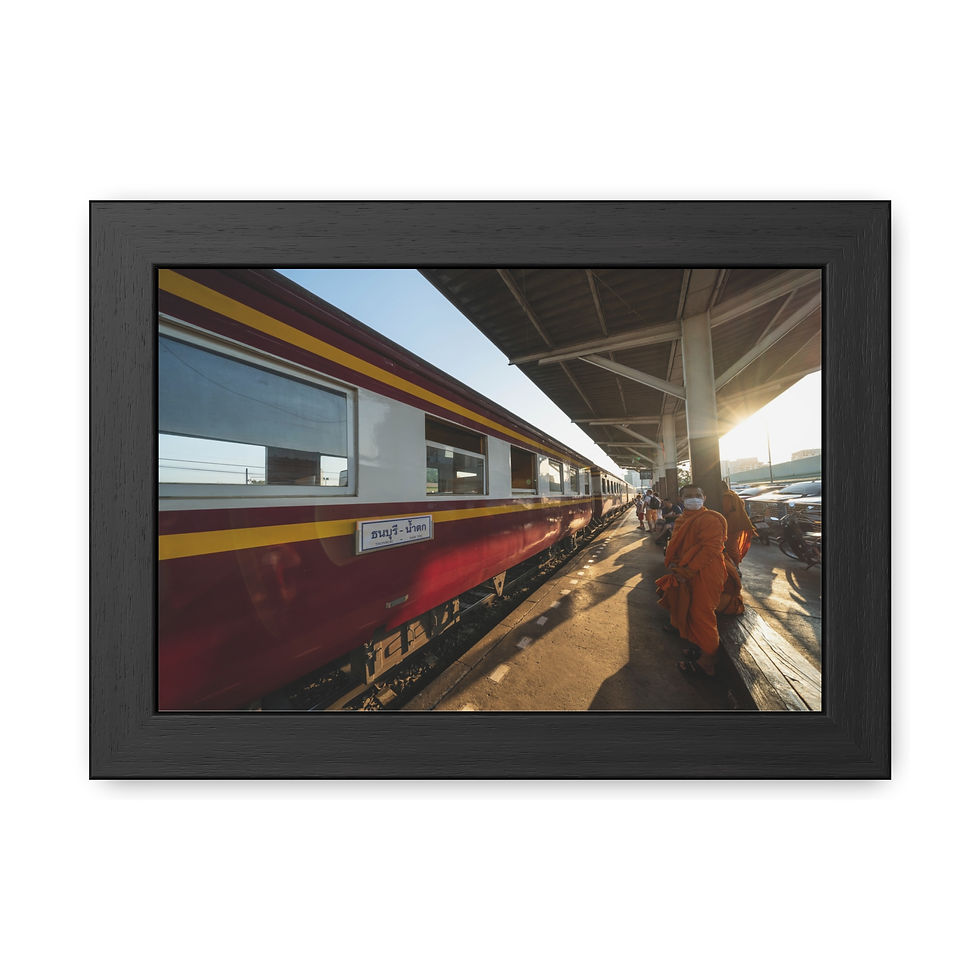 Thumbnail: Monk in orange robes walks beside train at station, sunset.