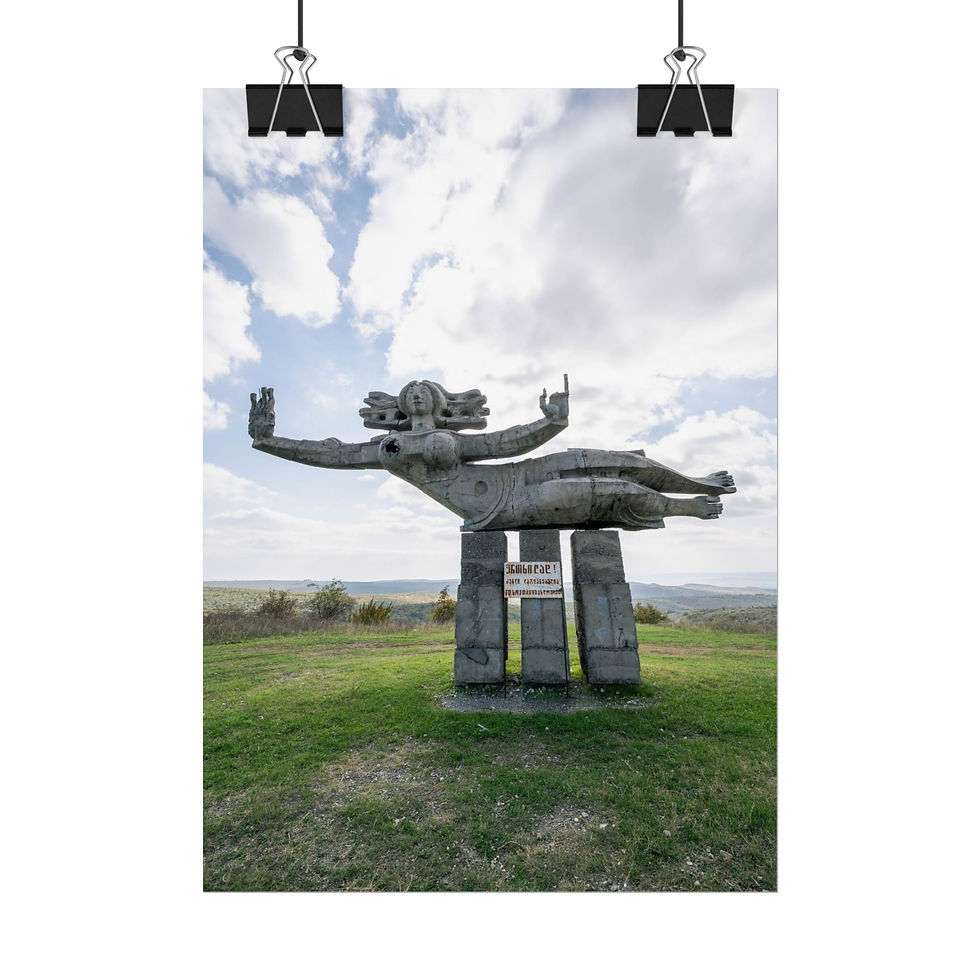 Thumbnail: Weathered concrete flying figure monument on a grassy hill under cloudy sky.