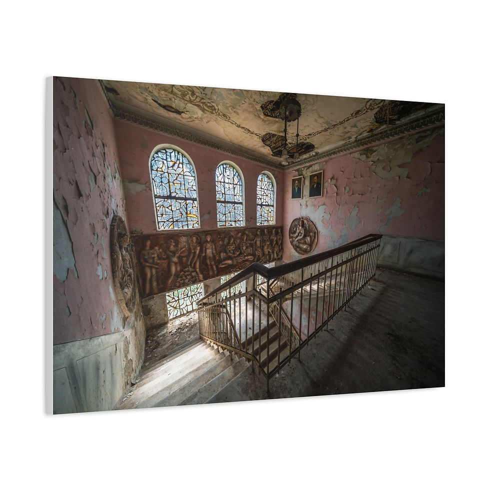 Thumbnail: Abandoned building's grand staircase with peeling paint and stained glass windows.