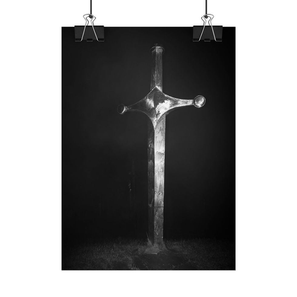 Thumbnail: Single, ornate sword standing upright in mist; black and white photography.