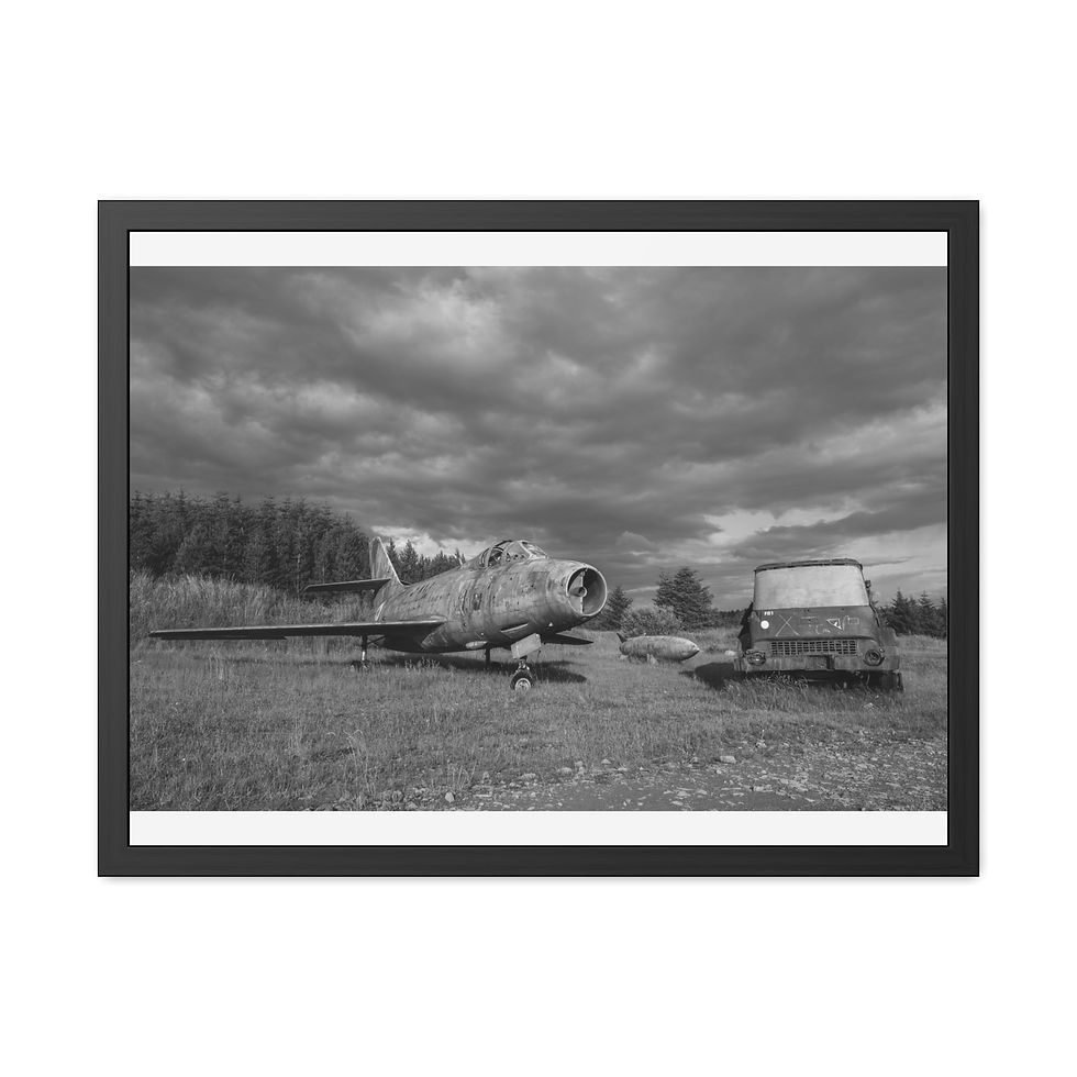 Thumbnail: Black and white abandoned military jet and old van, cloudy sky.