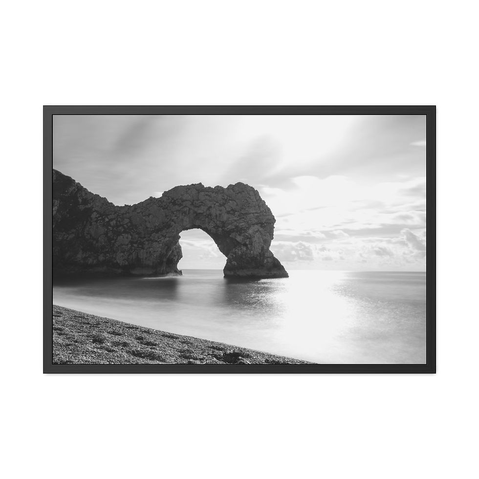 Thumbnail: Black and white natural rock arch over tranquil ocean at sunrise.