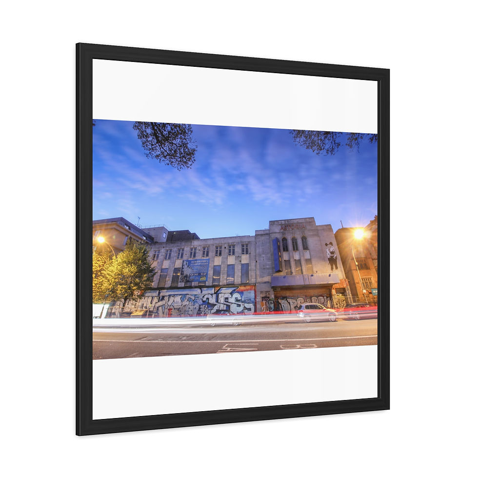 Thumbnail: Urban building at night with car light trails on busy street.