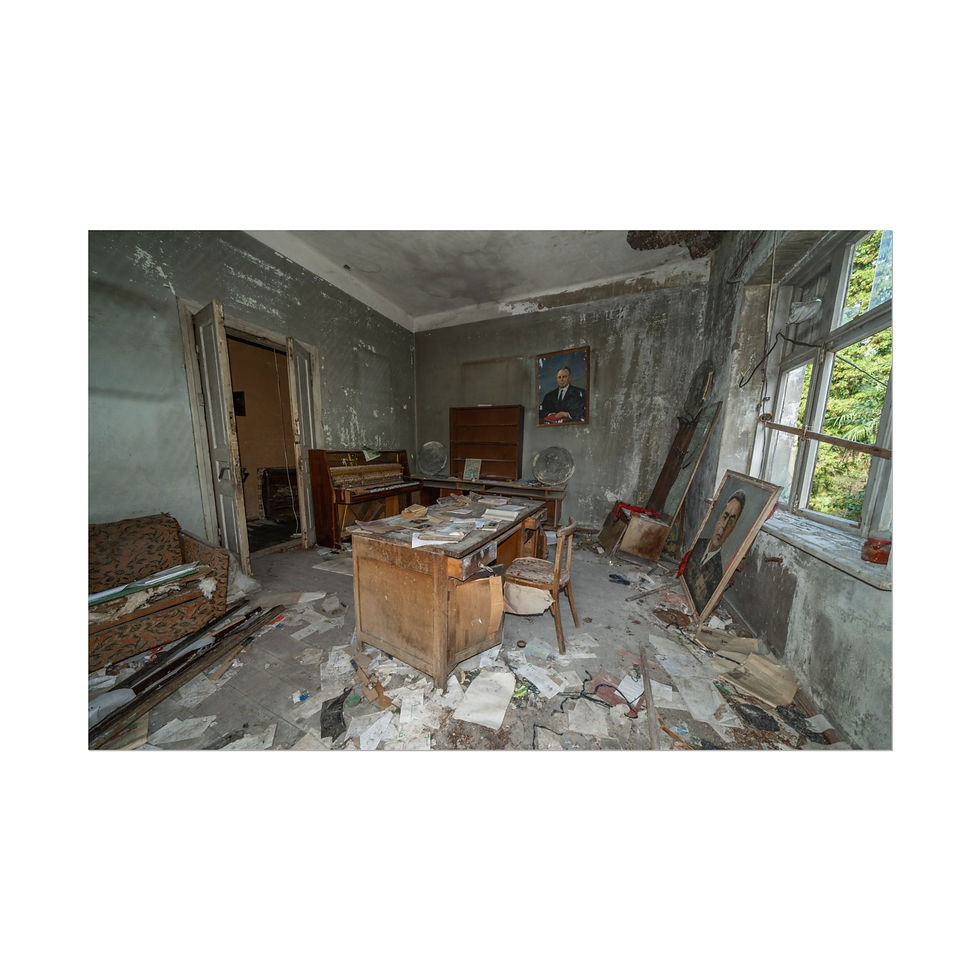 Thumbnail: Abandoned decaying office room with desk, chair, debris, and portrait.