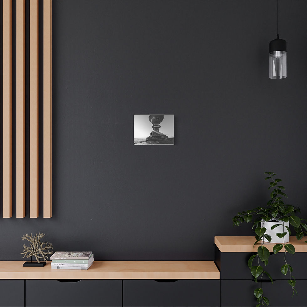 Thumbnail: Framed black and white photo of unique rock structure on dark grey wall.