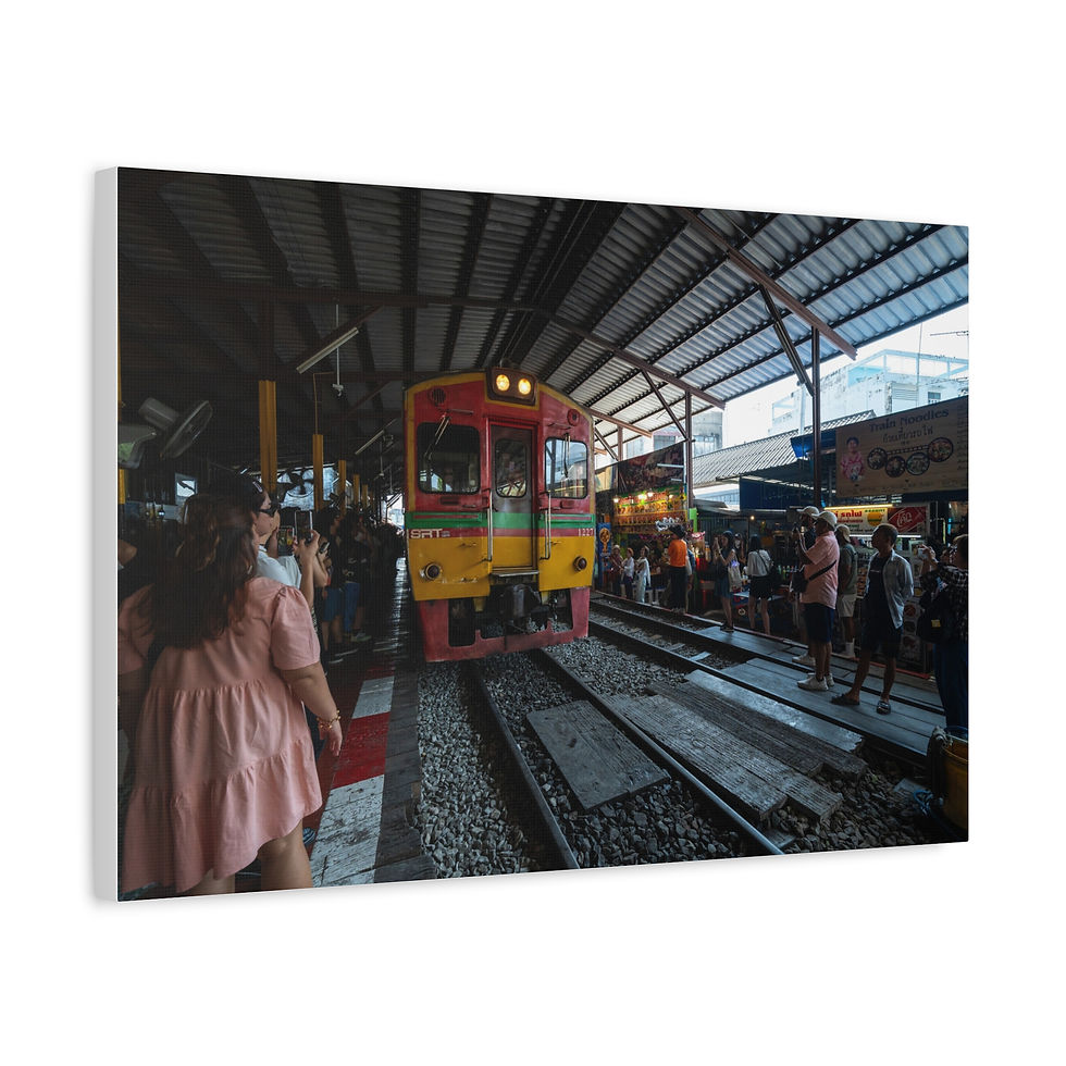 Thumbnail: Vibrant yellow and red train approaching a bustling market platform.