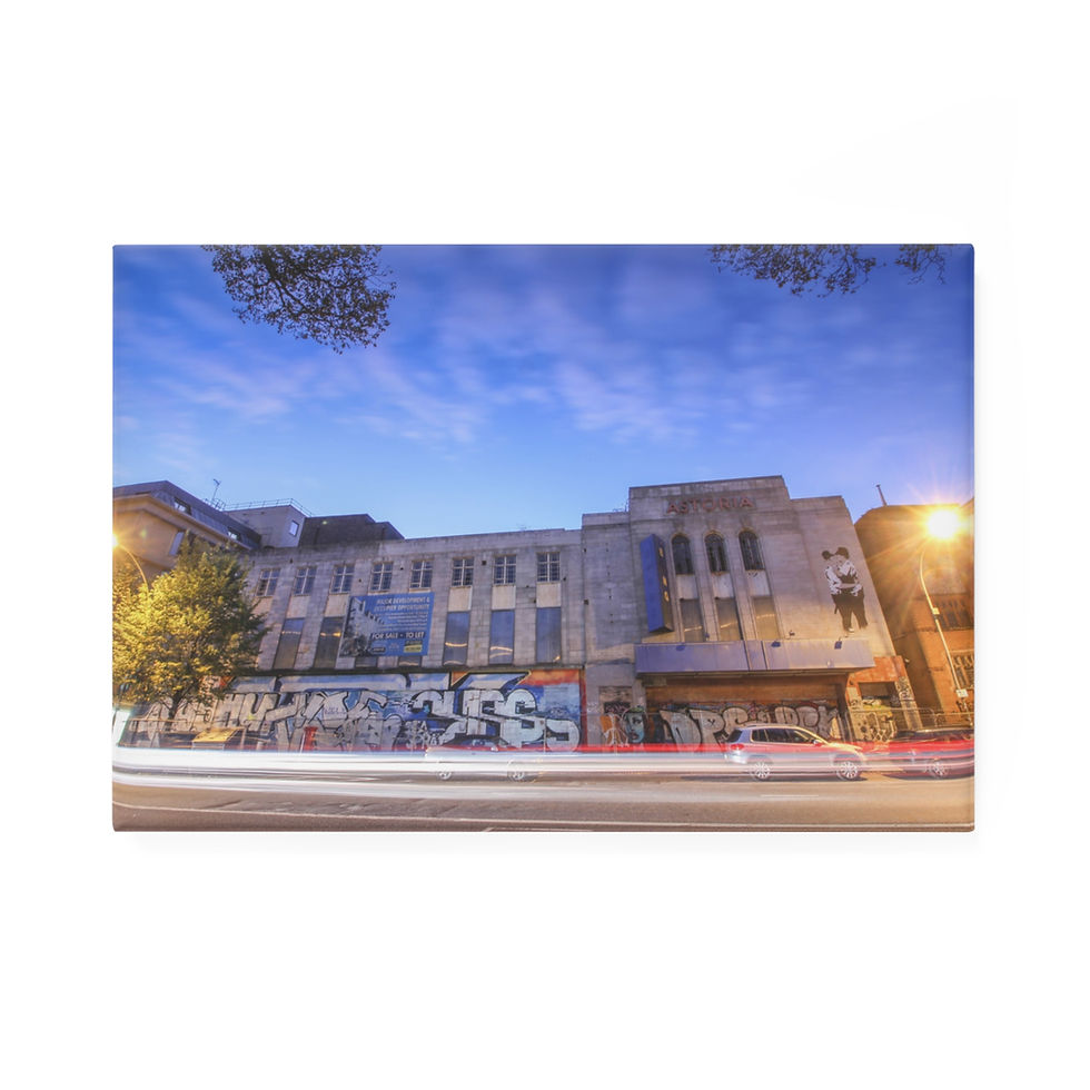 Thumbnail: Urban building covered in vibrant graffiti art, car light trails at night.