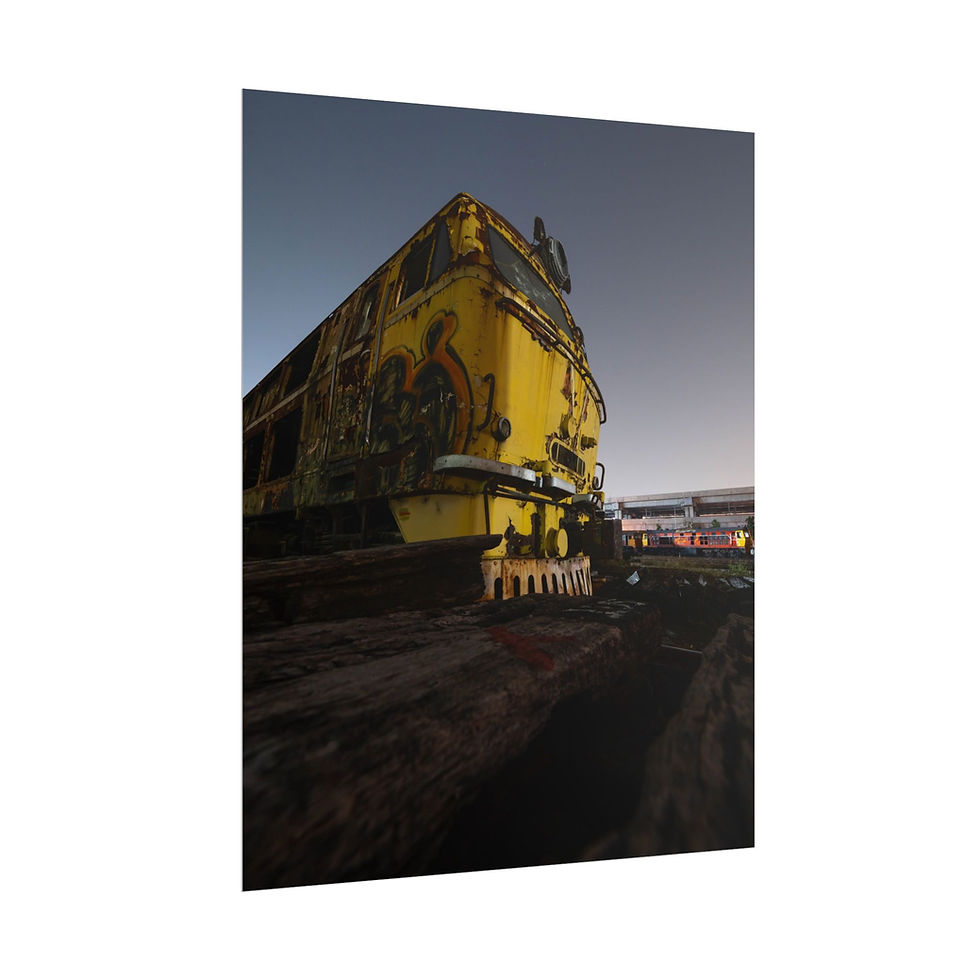 Thumbnail: Grungy, imposing yellow train locomotive under dark night sky, low angle.