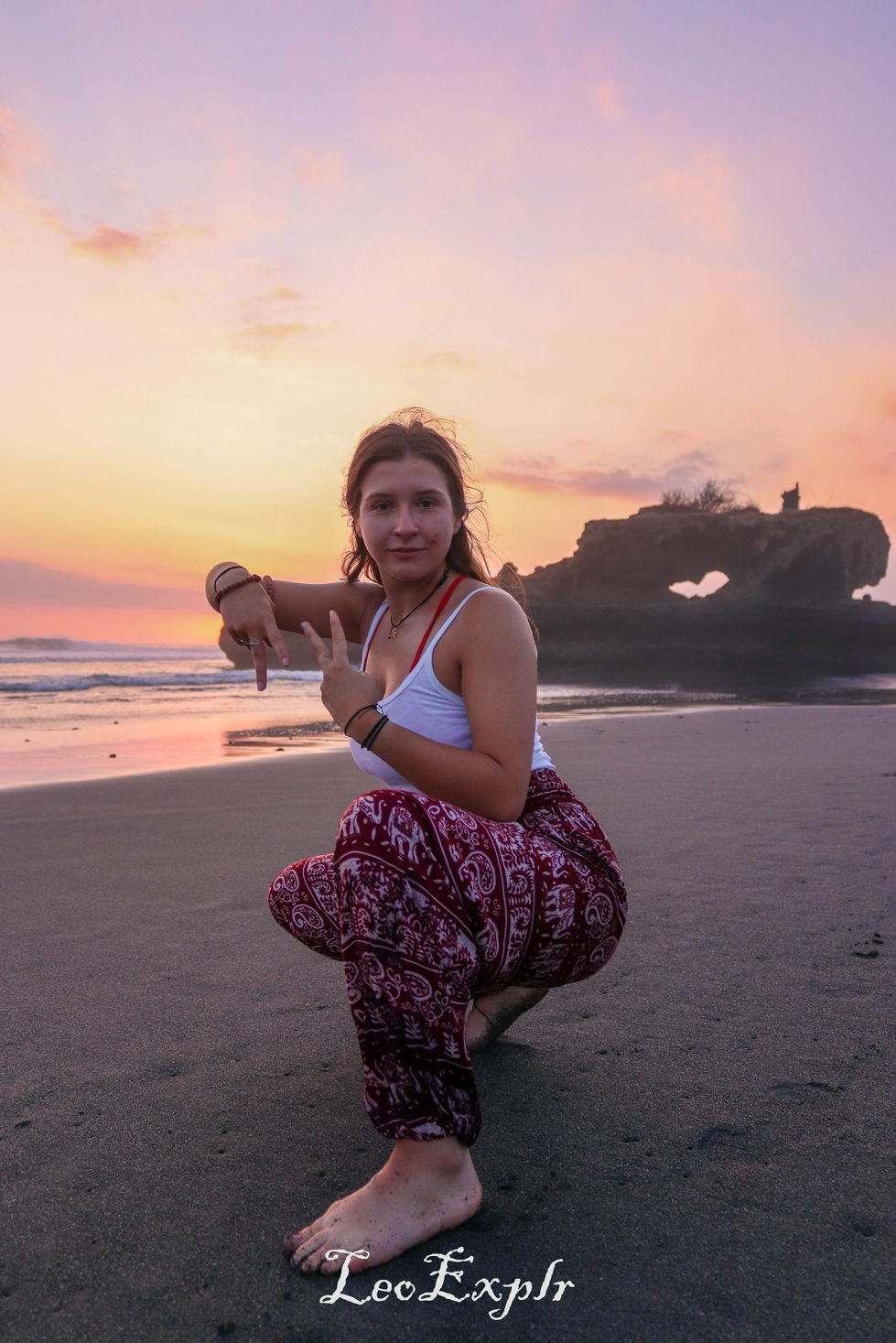Girl with pink trousers posing on Yeh Gangga beach