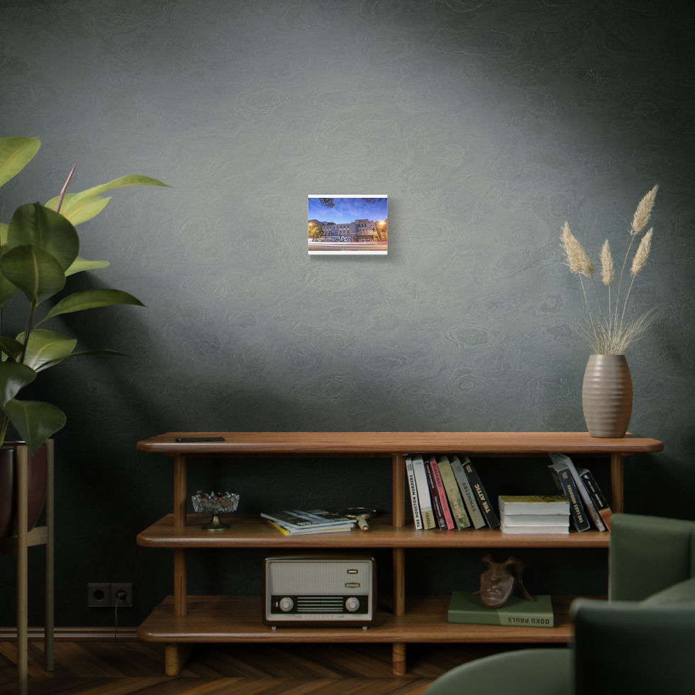 Thumbnail: Small framed seascape print hangs above a modern wooden console table.