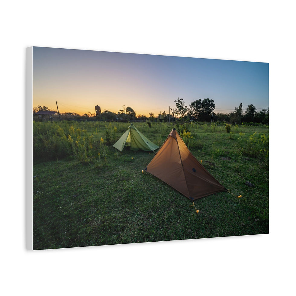 Thumbnail: Two camping tents in a green field under a clear sunset sky.