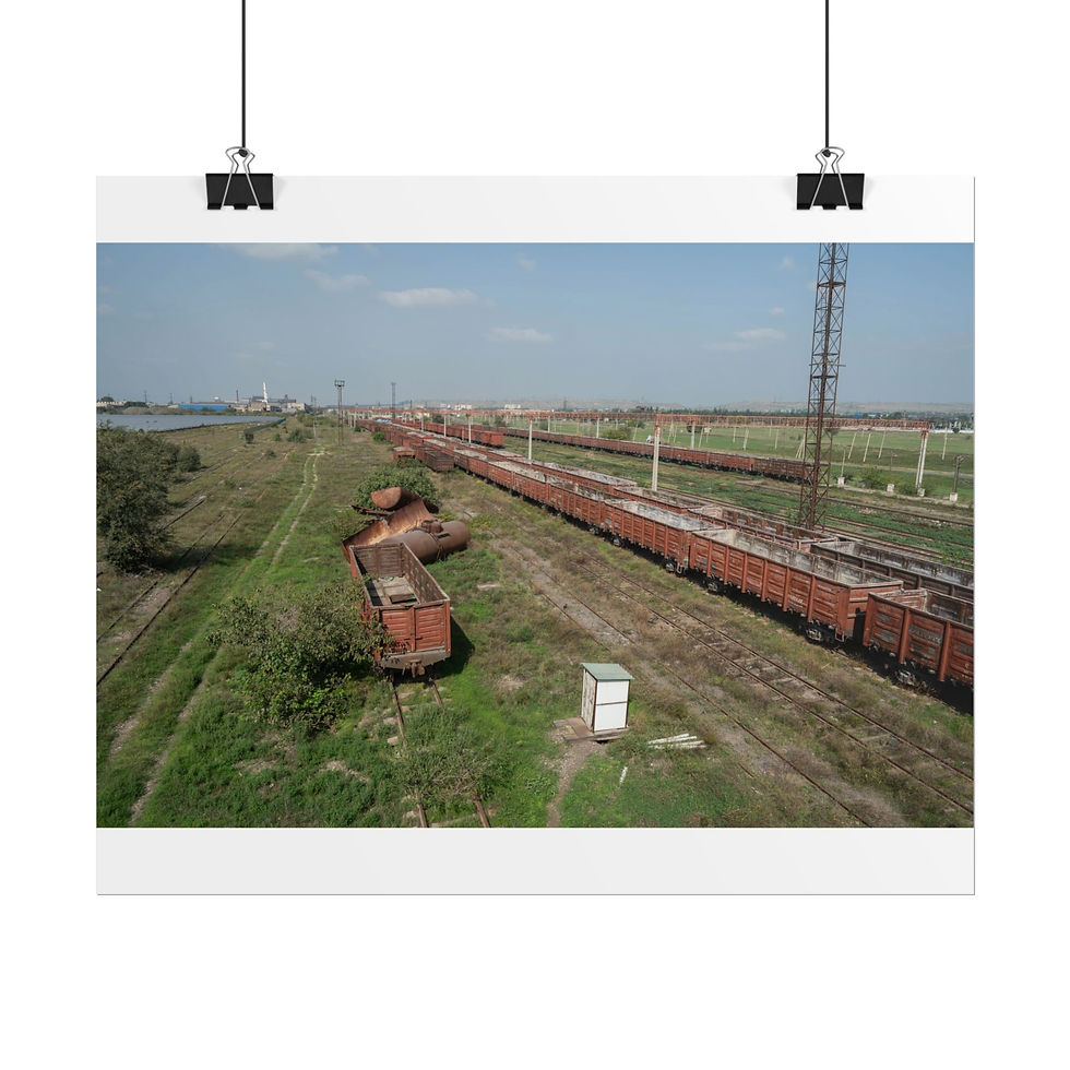 Thumbnail: Long red freight train on multiple tracks in a green landscape.