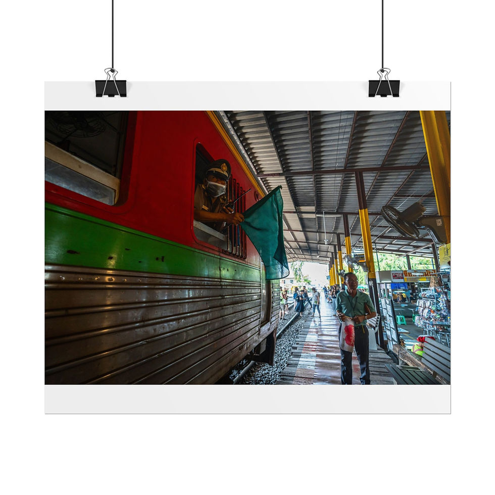 Thumbnail: Red and green train with green flag at station, person walking.