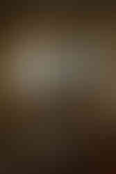 Aragats Scientific Center - Orgov Radio-Optical Telescope. A decaying room with broken windows and debris on the floor. Sunlight streams through, revealing an abandoned solar building outside and dry, hilly terrain.