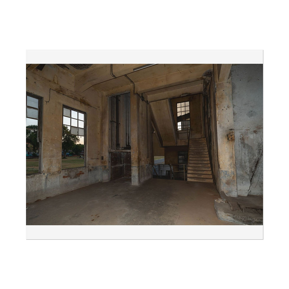 Thumbnail: Empty, dilapidated concrete room with large windows and a staircase.