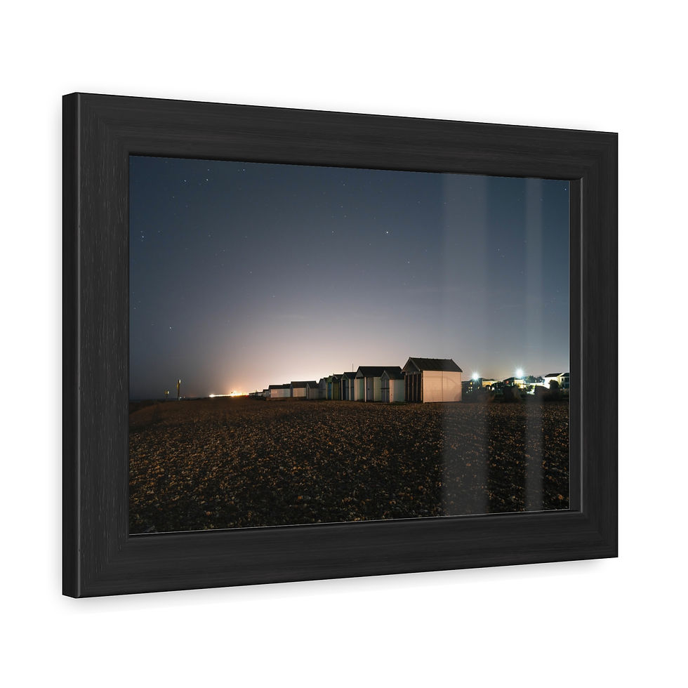 Thumbnail: Framed poster: coastal town buildings illuminated at night under a dark sky.