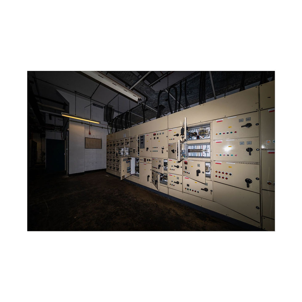 Thumbnail: Large industrial control panel with switches and dials in dark room.