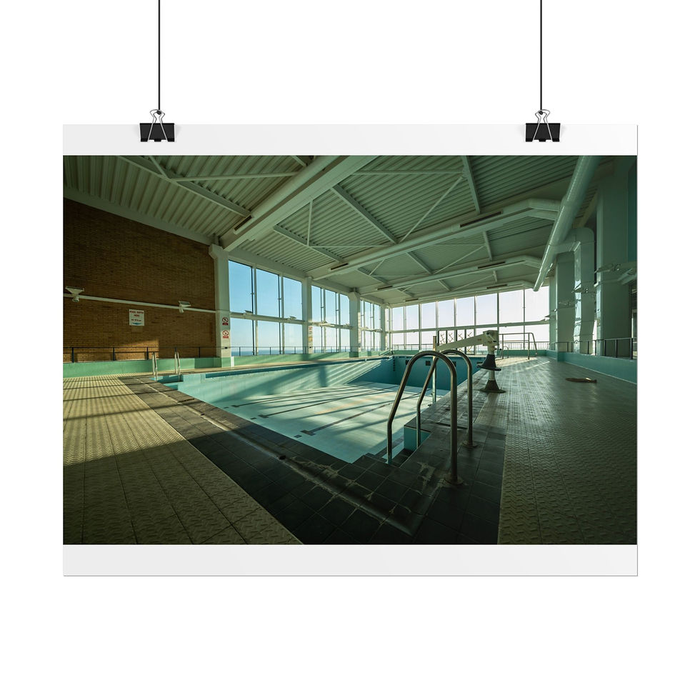Thumbnail: Empty, abandoned indoor swimming pool with sunlight streaming through large windows.