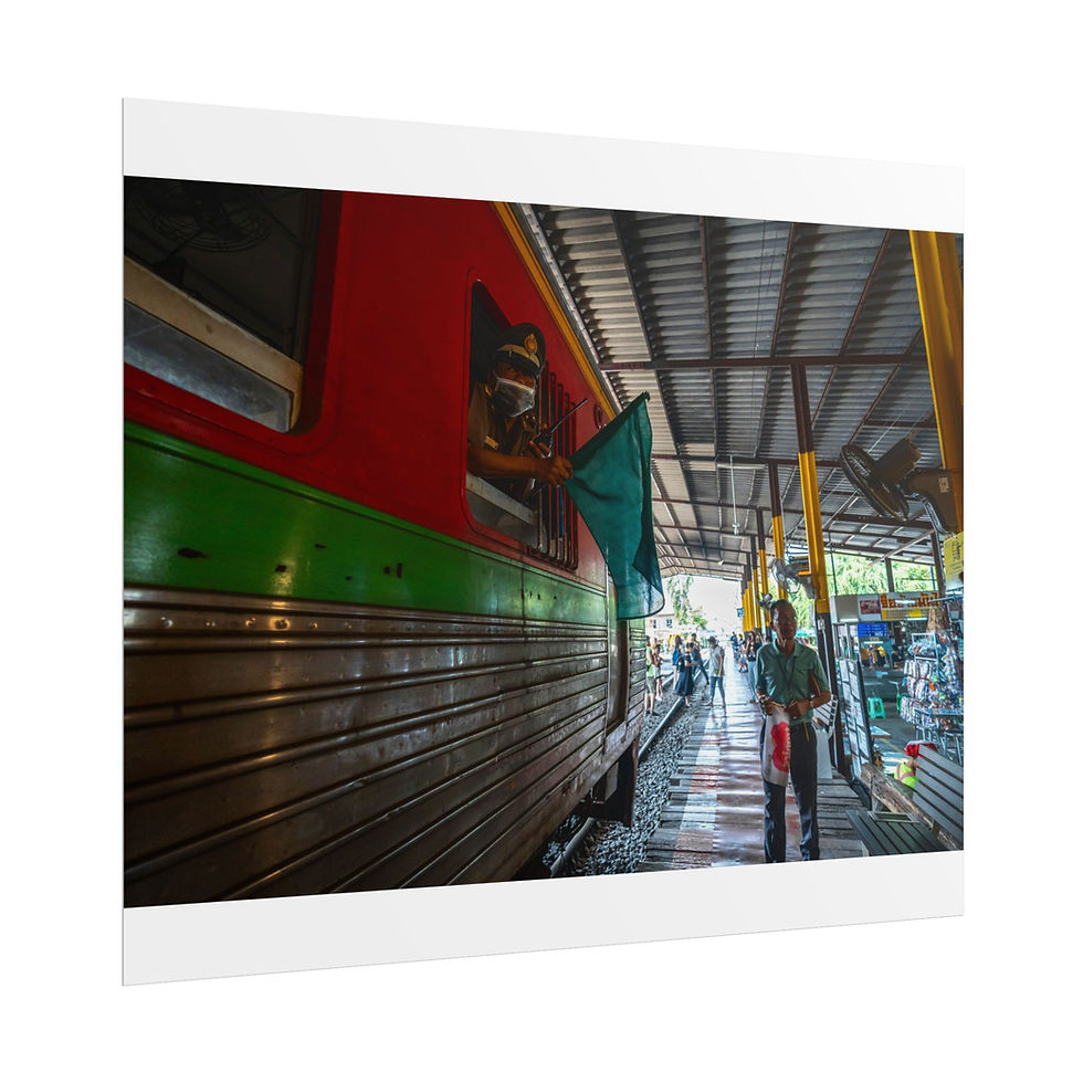 Thumbnail: Red and green train parked at station platform, person walking by.