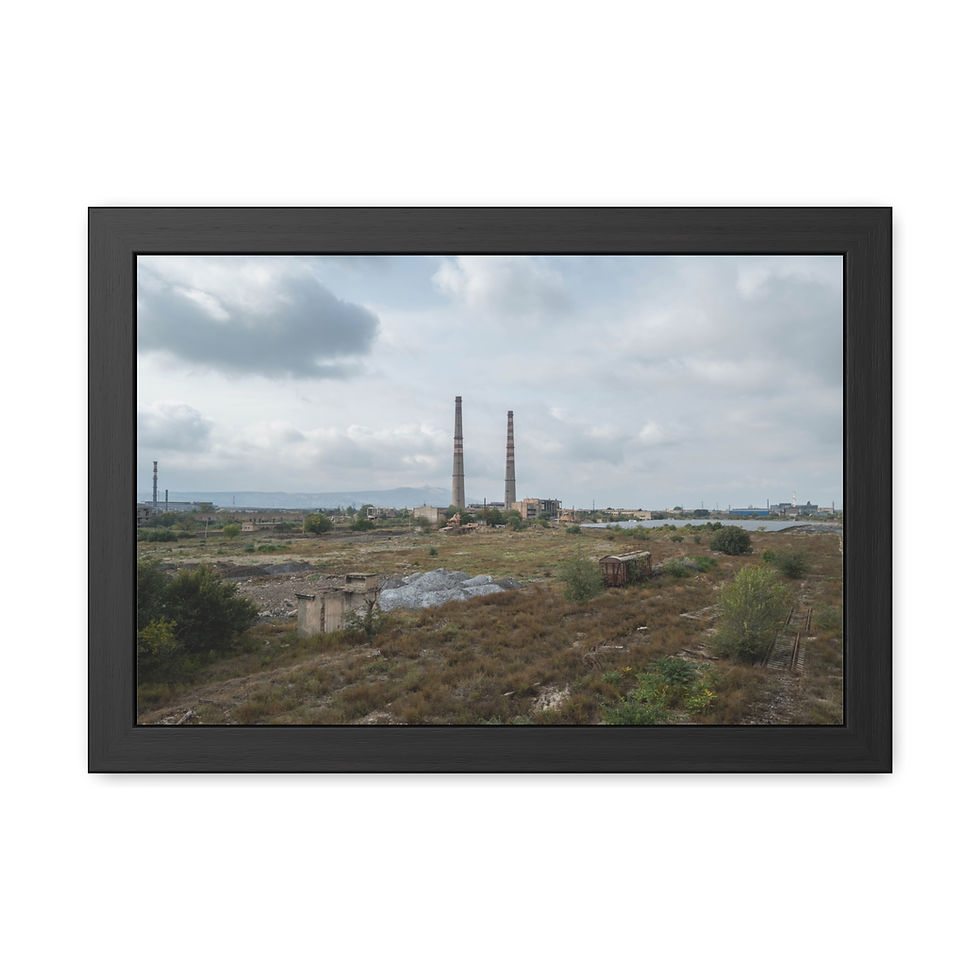 Thumbnail: Two tall smokestacks dominate industrial landscape under cloudy sky.