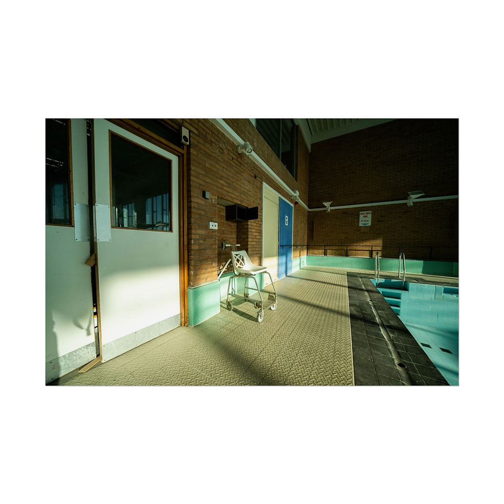 Thumbnail: Indoor swimming pool with empty chair lift and sunlit tiled floor.