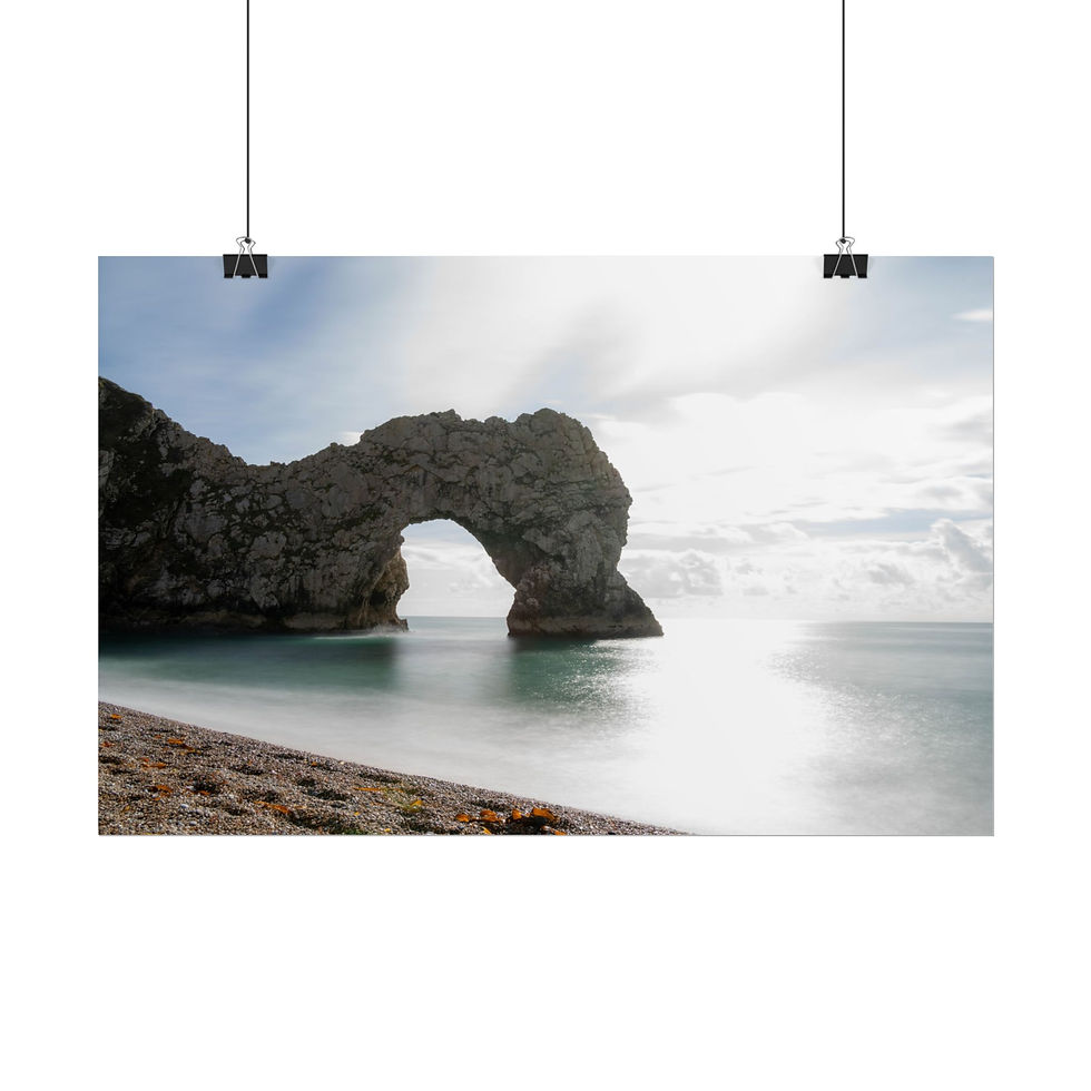 Thumbnail: Dramatic natural rock arch, serene sea, sunlit reflection, peaceful beach.