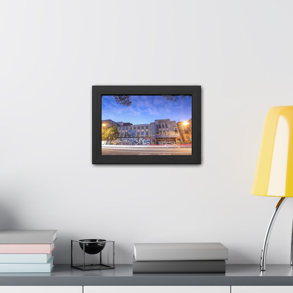 Thumbnail: Framed picture of an old building lit at night under blue sky.